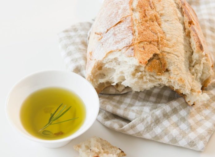 Close up of bread and olive oil on table